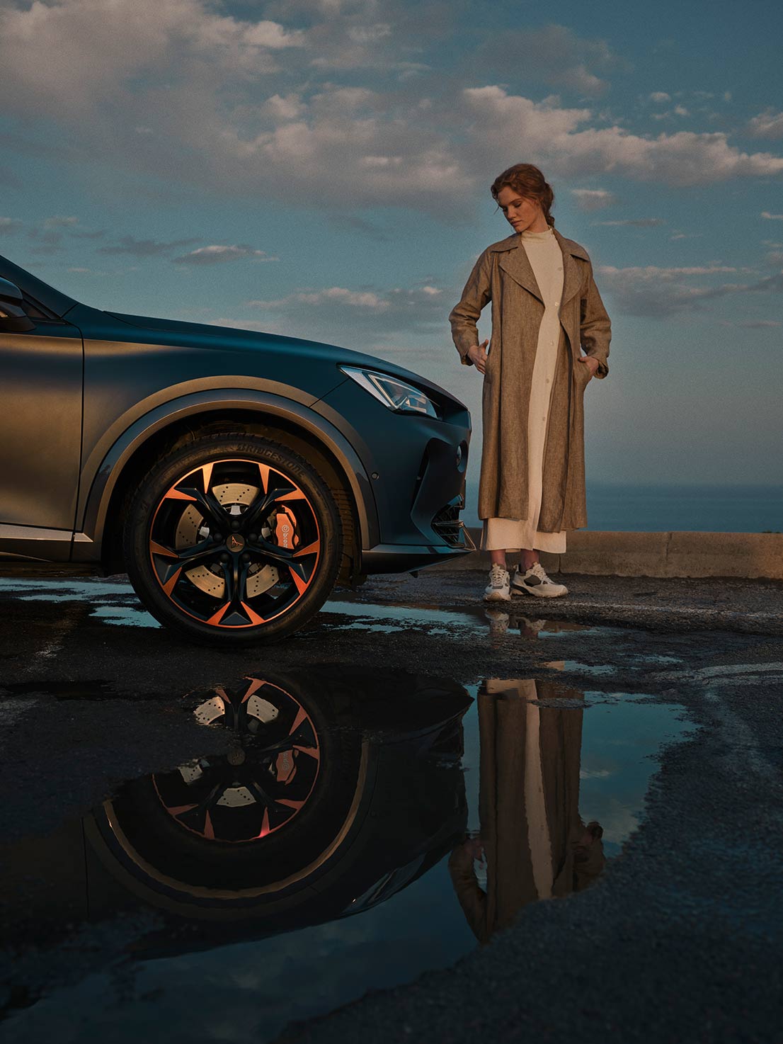 woman-standing-next-to-the new CUPRA Formentor  with brembo brak