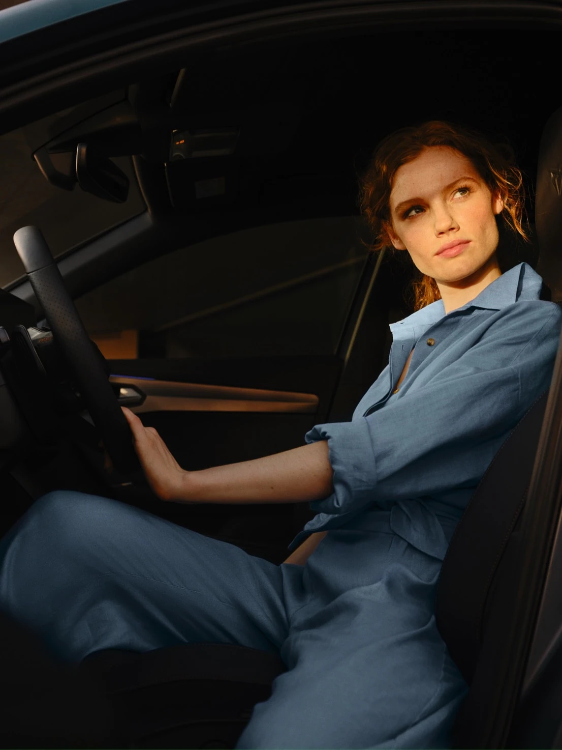 new-woman-sitting-inside-the-new-cupra-formentor-holding-the-steering-wheel-suv-compact-interior-car-design-and-bucket-seat